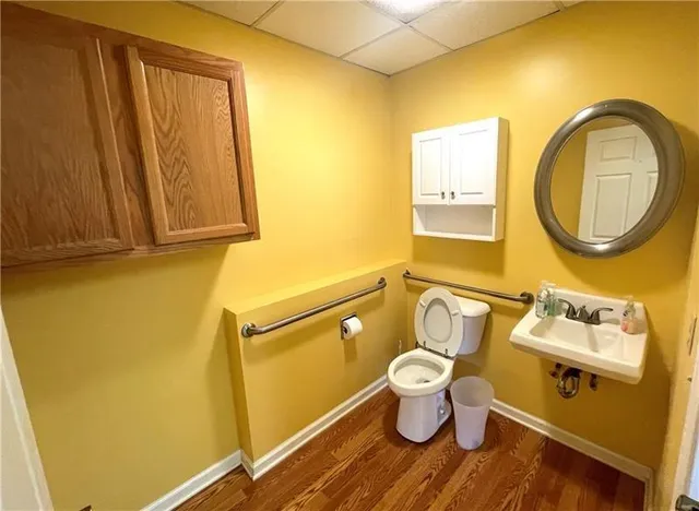 a bathroom with a toilet sink and mirror