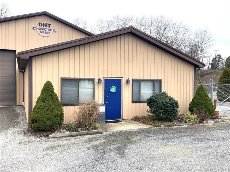 1227 Sunset Drive Butler, PA 16001 - Photo 2 of 13 a front view of a house with a yard and garage