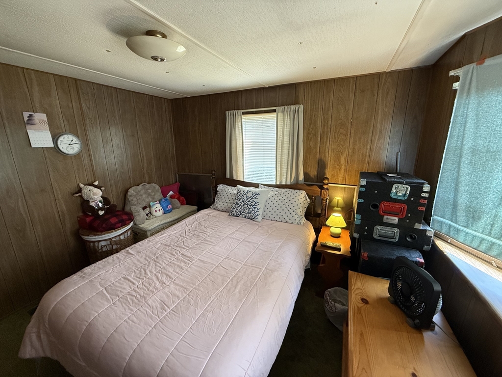 3132 Cranberry Highway, Unit 59 Wareham, MA 02538 - Photo 13 of 22 a bed room with a bed and a car