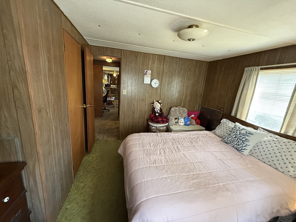 3132 Cranberry Highway, Unit 59 Wareham, MA 02538 - Photo 15 of 22 a bed room with a bed and a mirror