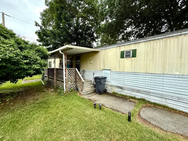 a backyard of a house with table and chairs