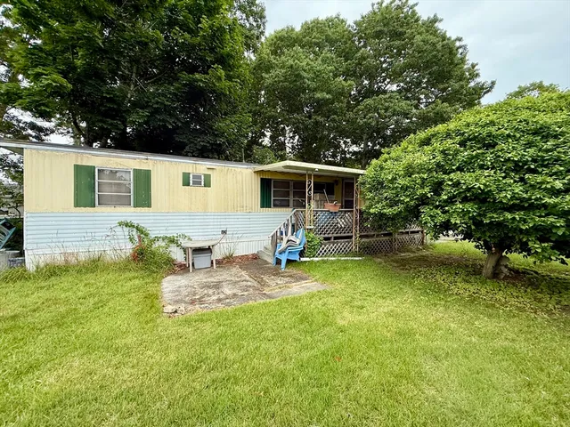 a front view of house with yard and seating area