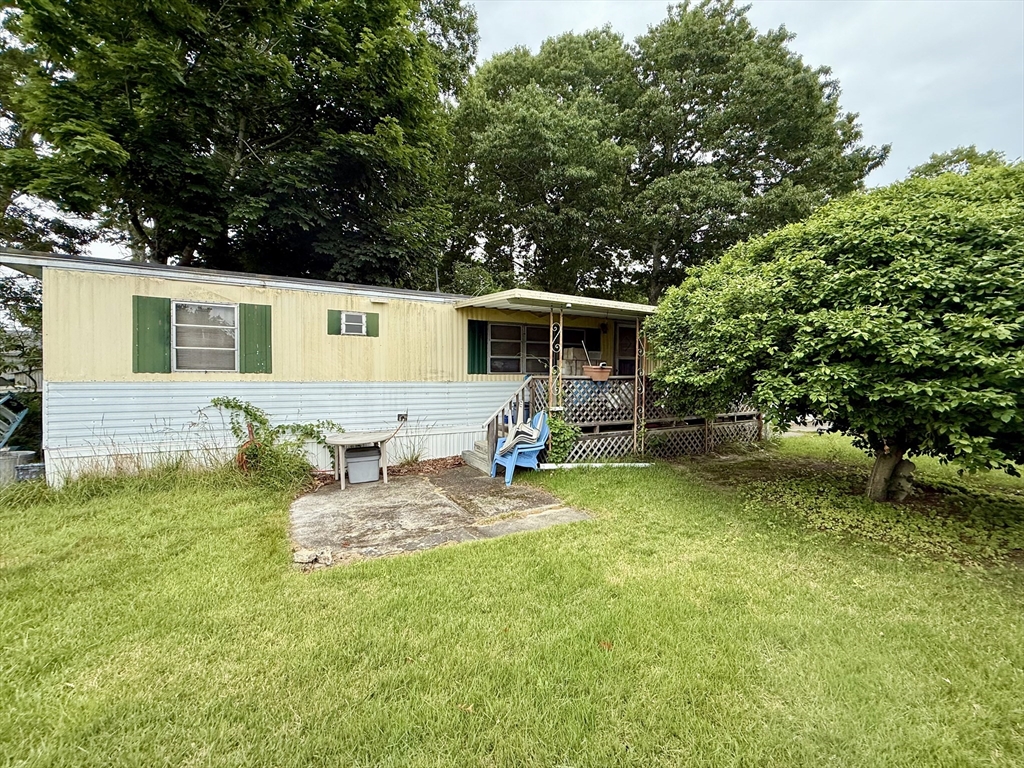 3132 Cranberry Highway, Unit 59 Wareham, MA 02538 - Photo 3 of 22 a front view of house with yard and seating area