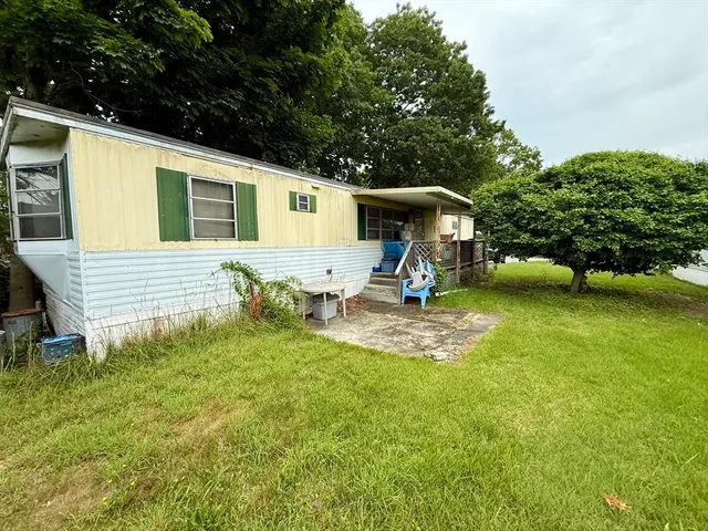a view of a backyard with a table and chairs