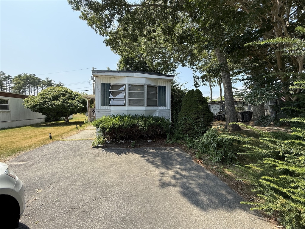 3132 Cranberry Highway, Unit 59 Wareham, MA 02538 - Photo 8 of 22 a view of a house with pool and a yard