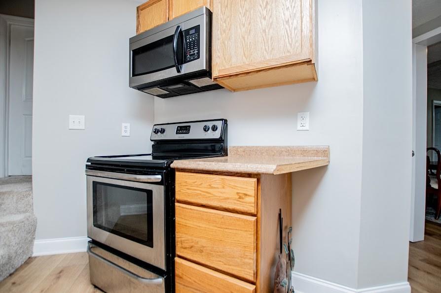 575 Liberty Church Road Carrollton, GA 30116 - Photo 49 of 95 a kitchen with stainless steel appliances granite countertop a stove microwave and sink