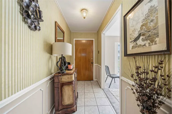 a view of a hallway to a livingroom with furniture