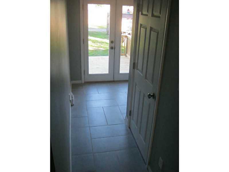 154 Center Street Springdale, PA 15144 - Photo 21 of 24 Other. Partial bath to right. Ceramic floor in "mud room" leads to deck.