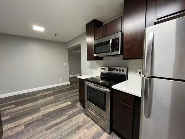 a kitchen with stainless steel appliances a refrigerator stove and microwave