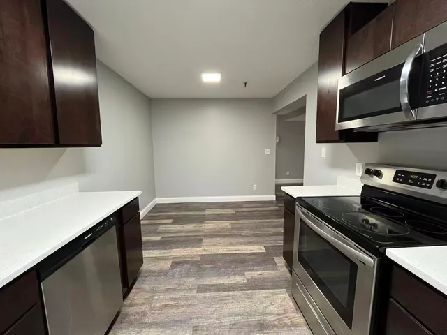 a kitchen with stainless steel appliances granite countertop a stove and a microwave