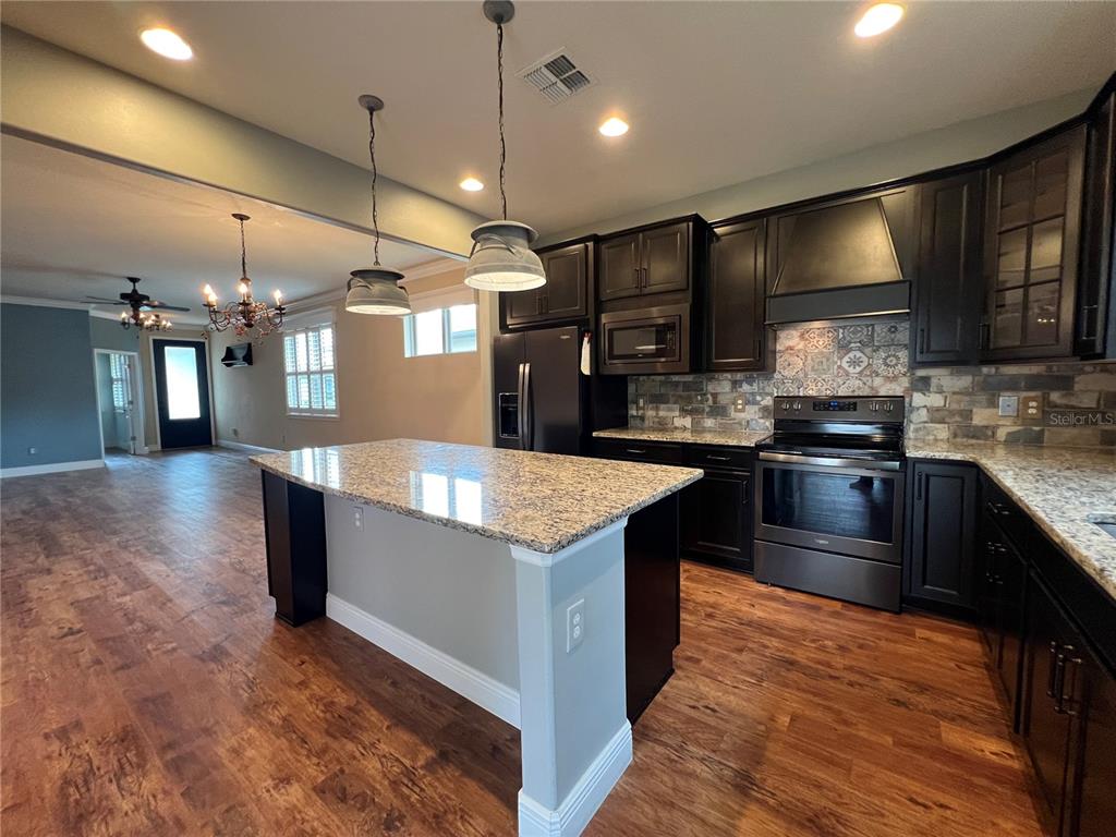 9515 Southwest 76th Street Ocala, FL 34481 - Photo 12 of 55 a large kitchen with stainless steel appliances a large counter top
