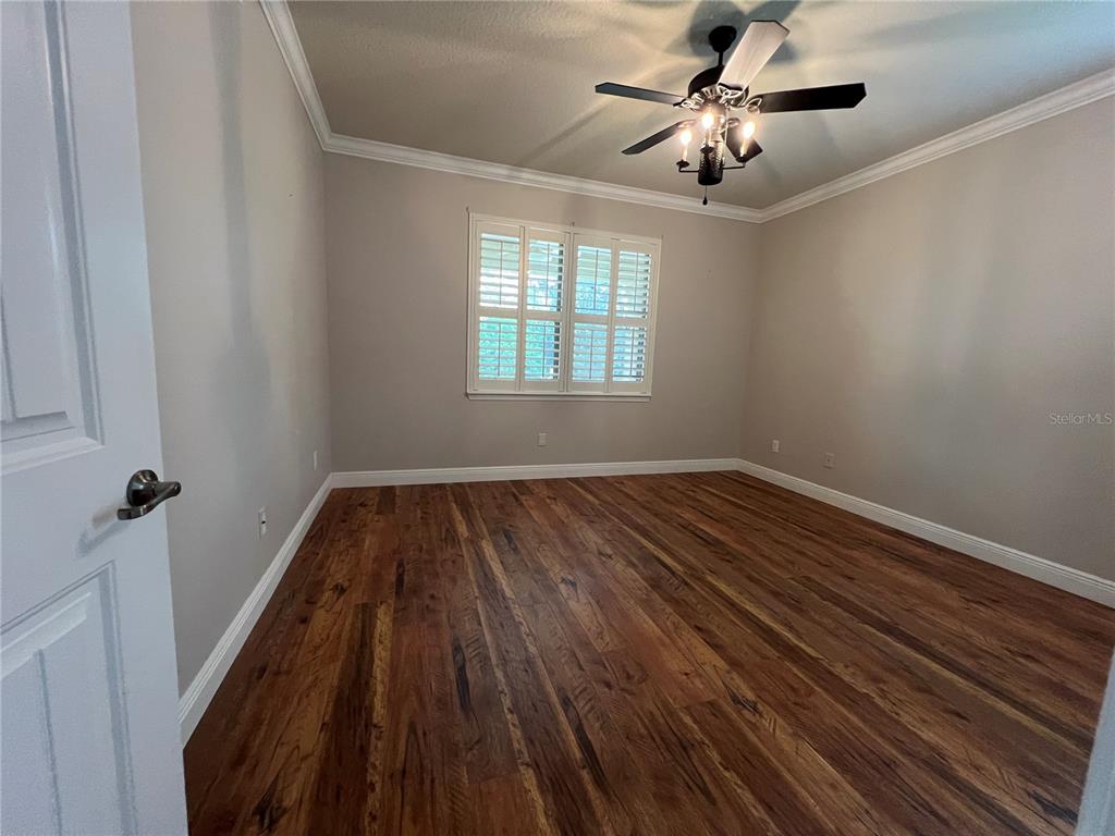 9515 Southwest 76th Street Ocala, FL 34481 - Photo 18 of 55 a view of empty room with wooden floor and fan
