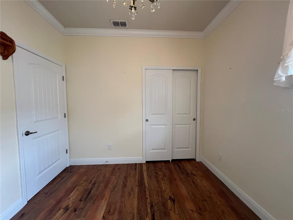 9515 Southwest 76th Street Ocala, FL 34481 - Photo 39 of 55 a view of an empty room with wooden floor and closet