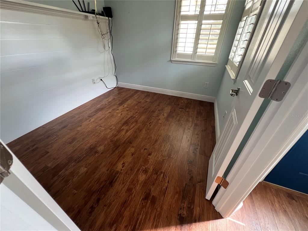 9515 Southwest 76th Street Ocala, FL 34481 - Photo 44 of 55 a view of an empty room with wooden floor and a window