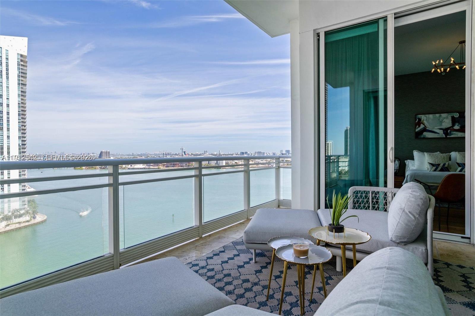 900 Brickell Key Boulevard, Unit 1502 Miami, FL 33131 - Photo 1 of 33 a living room with furniture and a potted plant