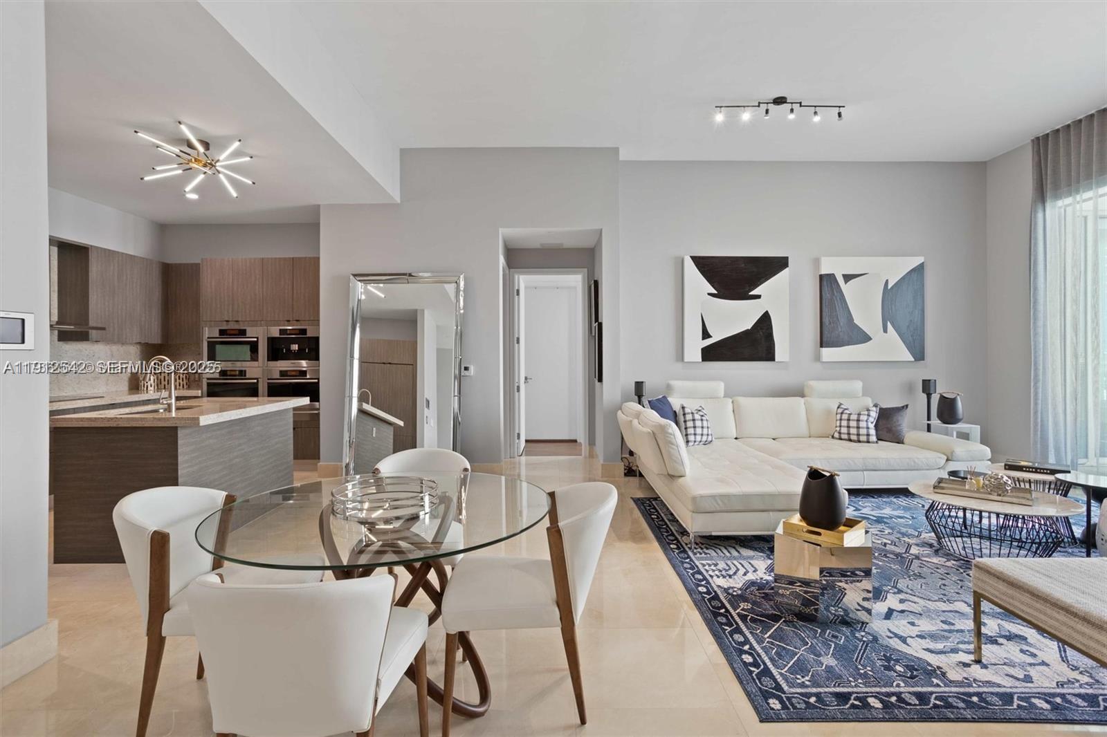 900 Brickell Key Boulevard, Unit 1502 Miami, FL 33131 - Photo 14 of 33 a living room with furniture and kitchen view