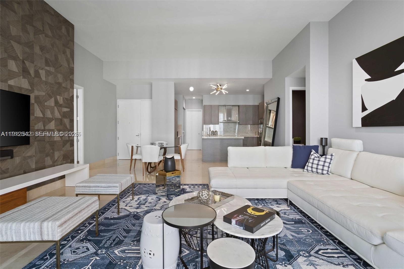 900 Brickell Key Boulevard, Unit 1502 Miami, FL 33131 - Photo 15 of 33 a living room with furniture and a flat screen tv