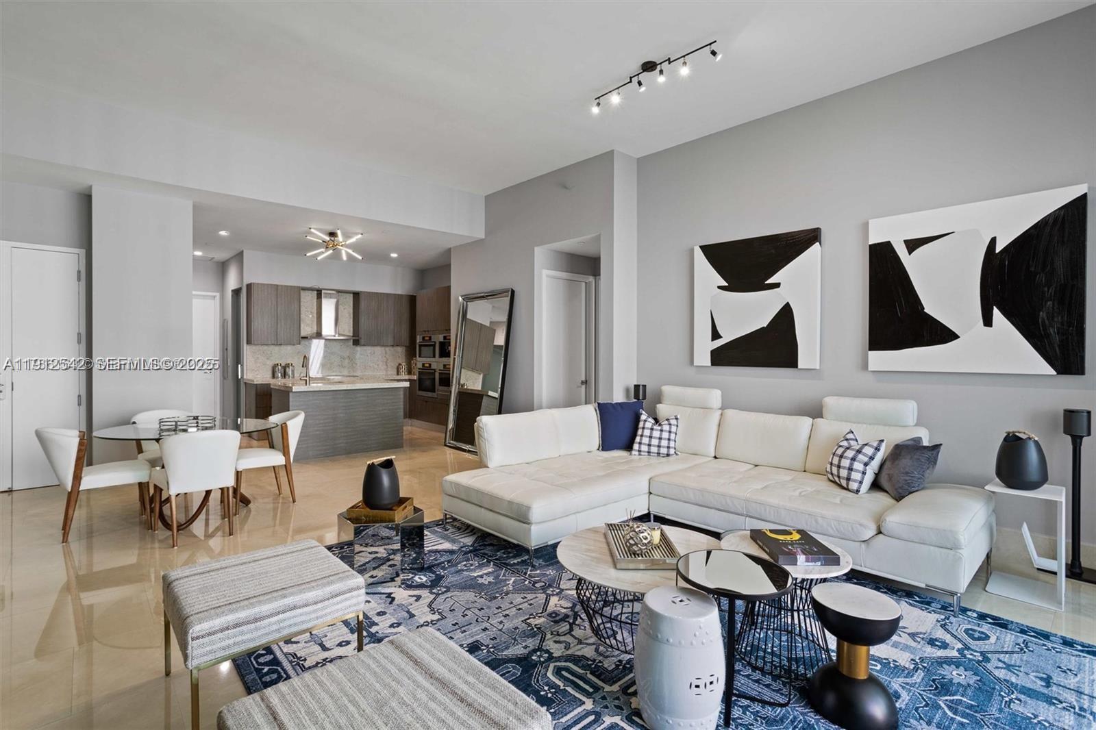 900 Brickell Key Boulevard, Unit 1502 Miami, FL 33131 - Photo 16 of 33 a living room with furniture wooden floor and kitchen view