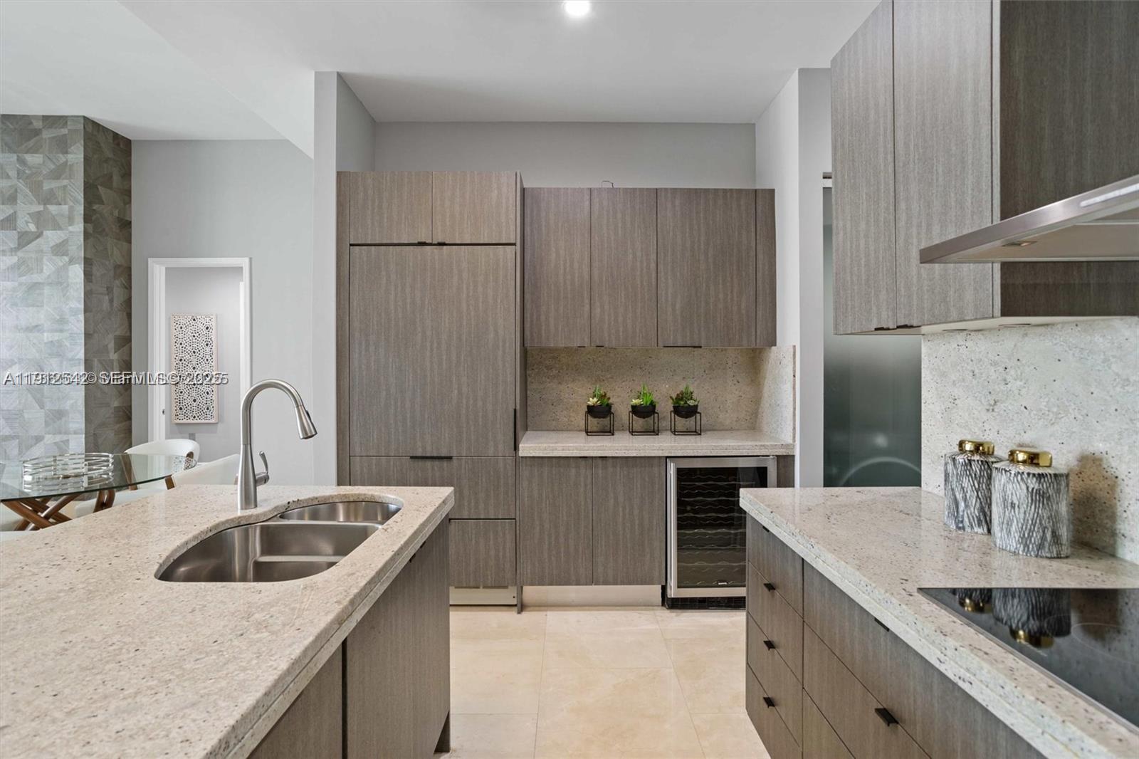 900 Brickell Key Boulevard, Unit 1502 Miami, FL 33131 - Photo 19 of 33 a kitchen with a sink stove and cabinets