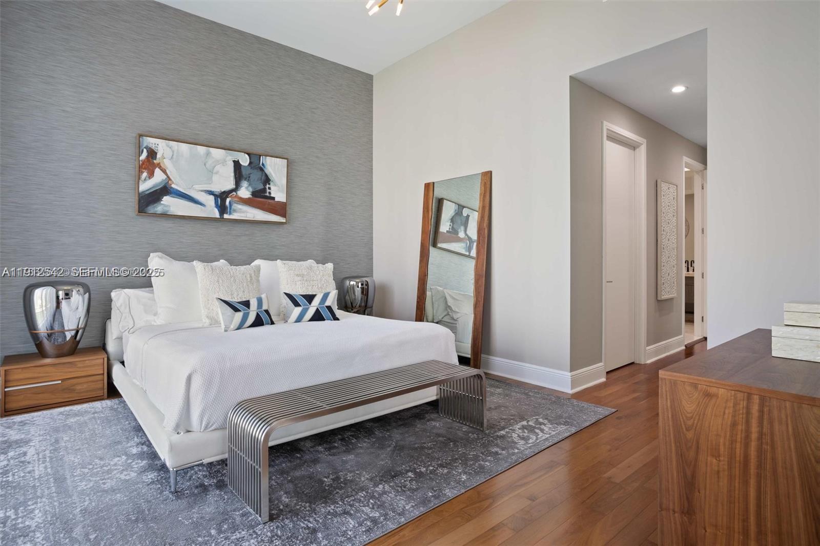 900 Brickell Key Boulevard, Unit 1502 Miami, FL 33131 - Photo 20 of 33 a spacious bedroom with a bed and a couch