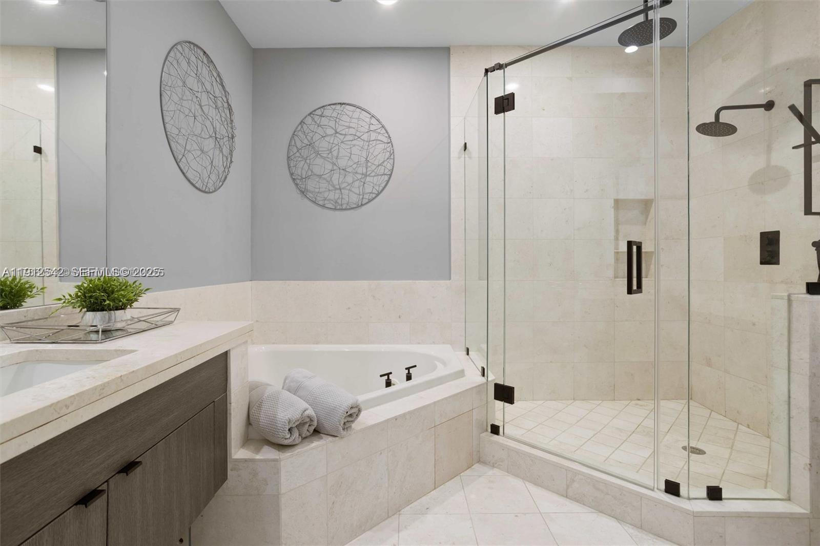 900 Brickell Key Boulevard, Unit 1502 Miami, FL 33131 - Photo 22 of 33 a bathroom with a bathtub a shower and a sink