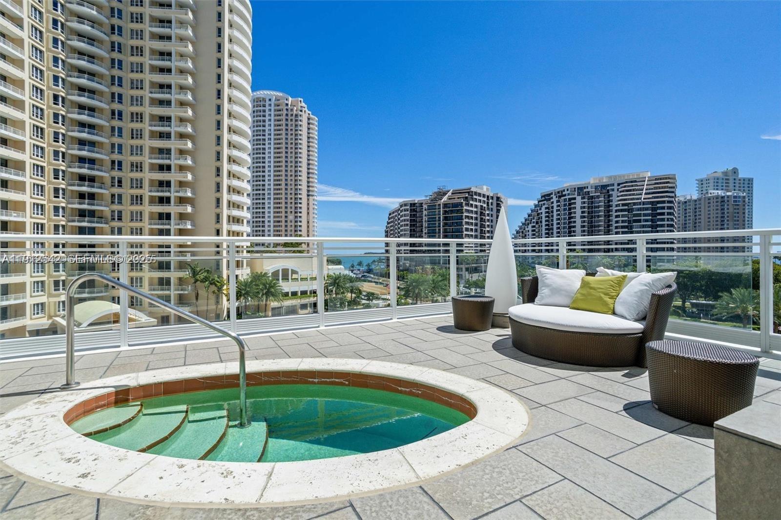 900 Brickell Key Boulevard, Unit 1502 Miami, FL 33131 - Photo 27 of 33 a swimming pool with outdoor seating