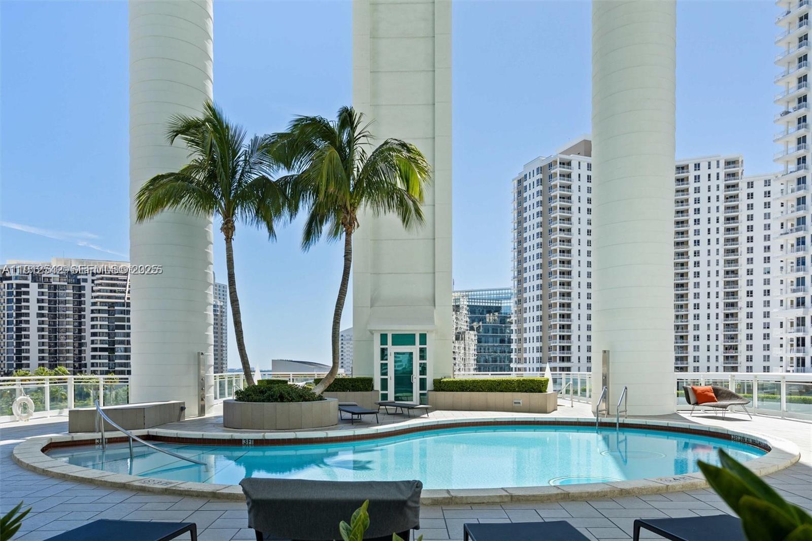 900 Brickell Key Boulevard, Unit 1502 Miami, FL 33131 - Photo 28 of 33 a view of a tall building with a outdoor space