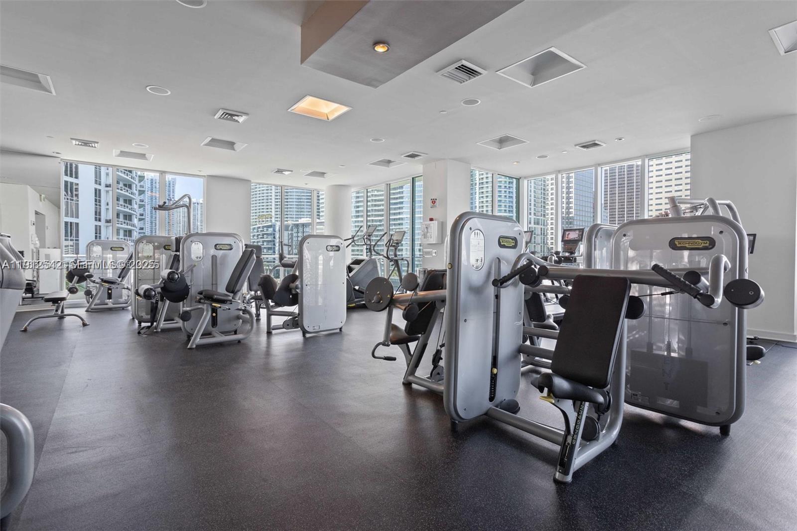 900 Brickell Key Boulevard, Unit 1502 Miami, FL 33131 - Photo 29 of 33 a view of a room with gym equipment