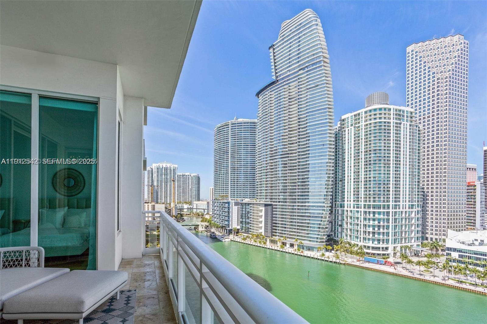 900 Brickell Key Boulevard, Unit 1502 Miami, FL 33131 - Photo 6 of 33 a view of balcony with two large windows and potted plants