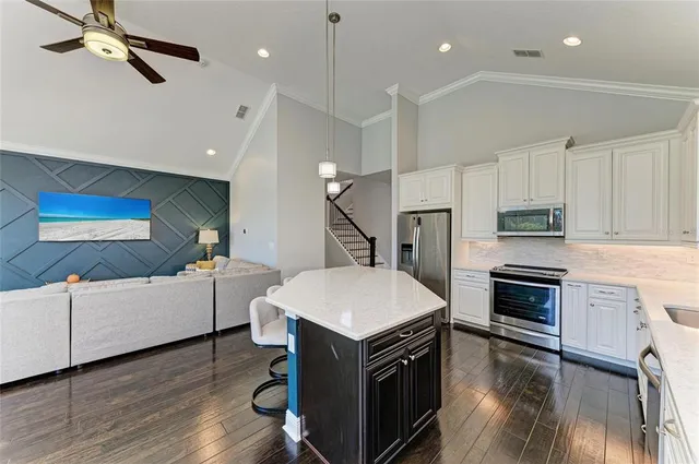 a kitchen with counter and wooden cabinets