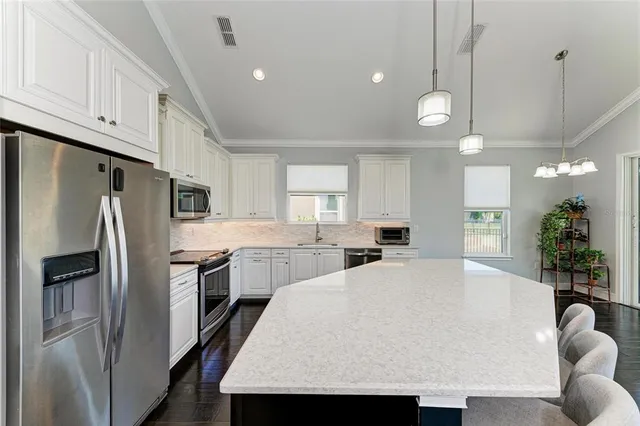 a large kitchen with a table and chairs