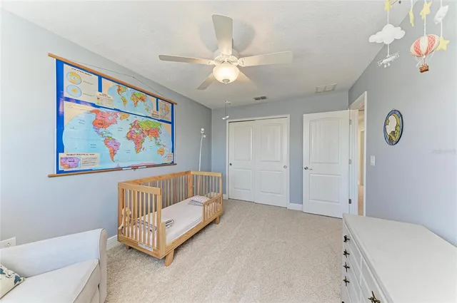 a living room with furniture and a book shelf