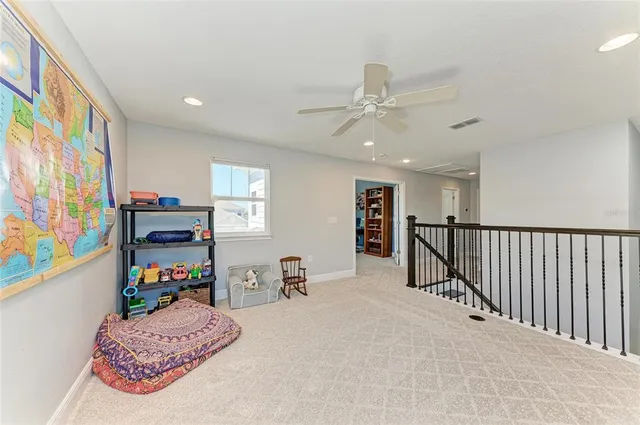 a view of a backyard with couches under an umbrella