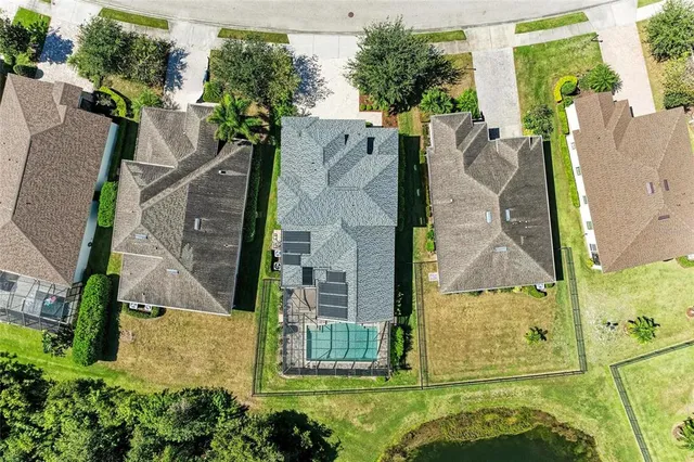 an aerial view of a house with a yard