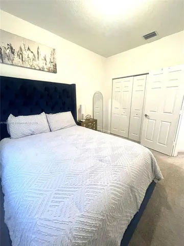 a large white bed in a white room