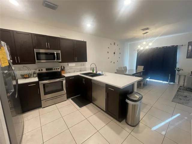 a kitchen with a sink a stove and cabinets
