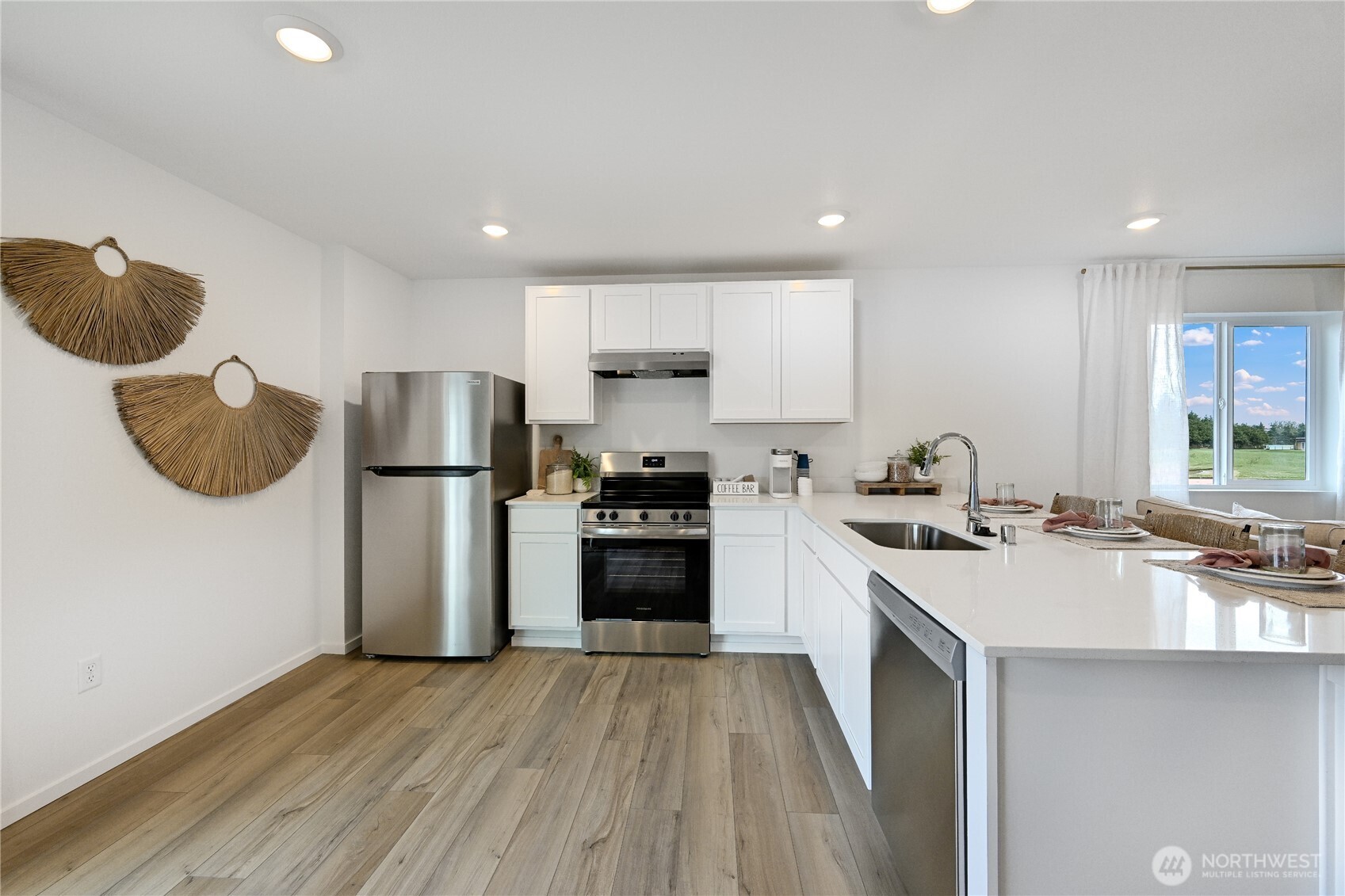 83 Moonshadow Lane Sequim, WA 98382 - Photo 5 of 22 a kitchen with a sink a refrigerator and cabinets