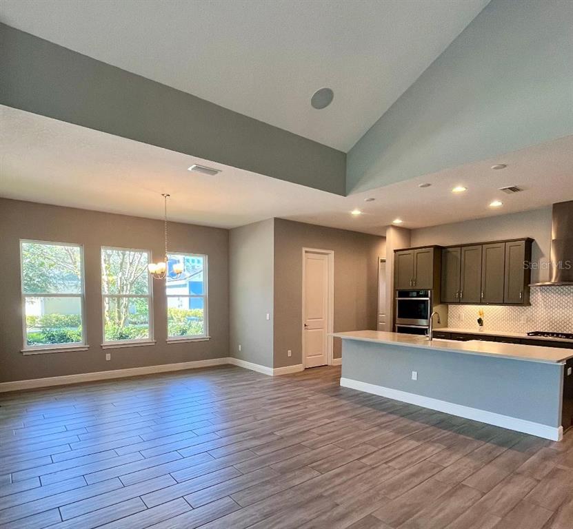5901 Nature Ridge Lane Lithia, FL 33547 - Photo 12 of 51 a view of kitchen with kitchen island wooden floor and living room
