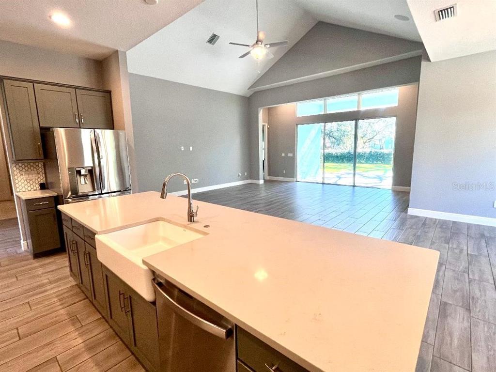 5901 Nature Ridge Lane Lithia, FL 33547 - Photo 14 of 51 a kitchen with stainless steel appliances a sink and a large window