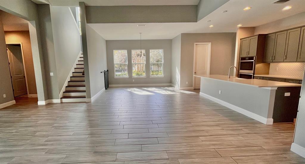 5901 Nature Ridge Lane Lithia, FL 33547 - Photo 14 of 54 an empty room with wooden floor and windows