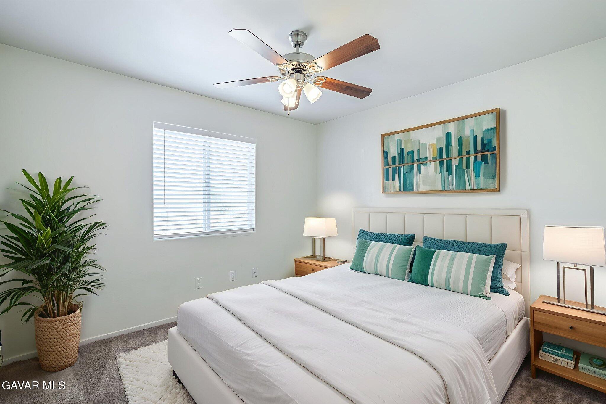 2400 Sunset Ridge Drive Rosamond, CA 93560 - Photo 15 of 34 a bedroom with a bed and a chandelier