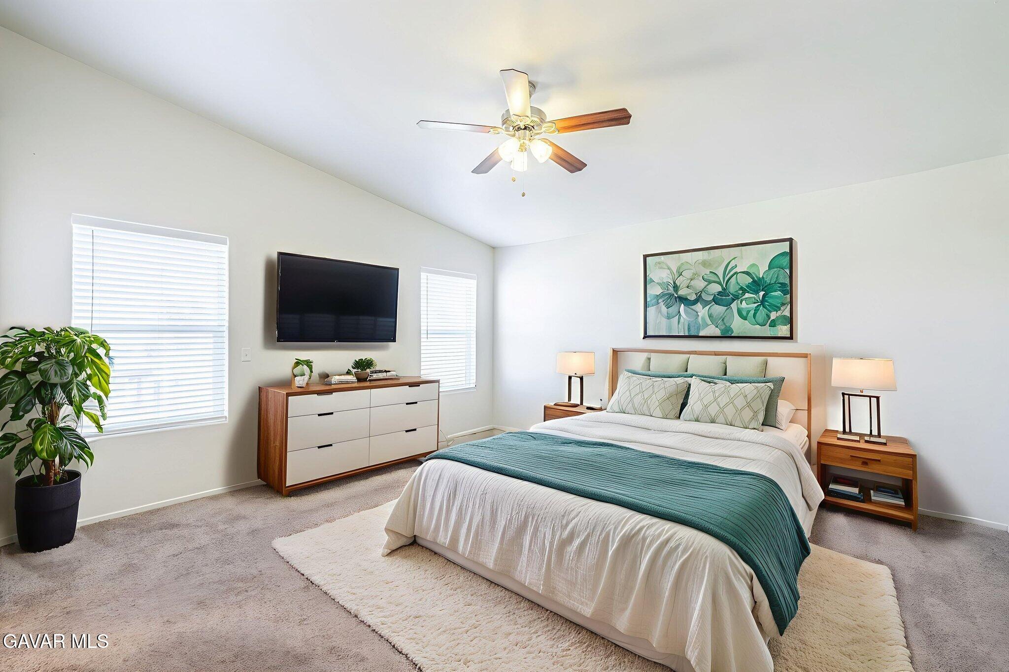 2400 Sunset Ridge Drive Rosamond, CA 93560 - Photo 17 of 34 a bedroom with a bed and a flat screen tv