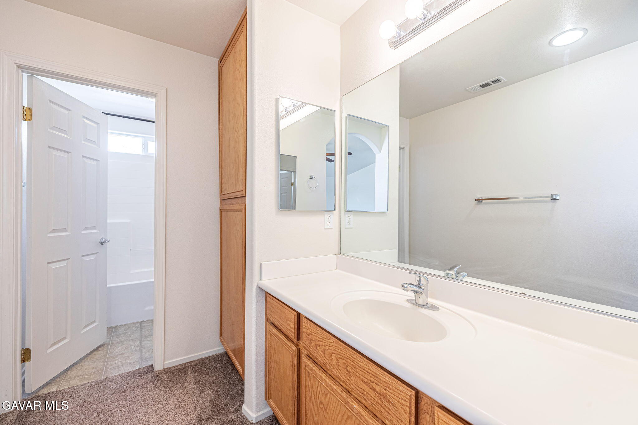 2400 Sunset Ridge Drive Rosamond, CA 93560 - Photo 19 of 34 a bathroom with a sink and a mirror