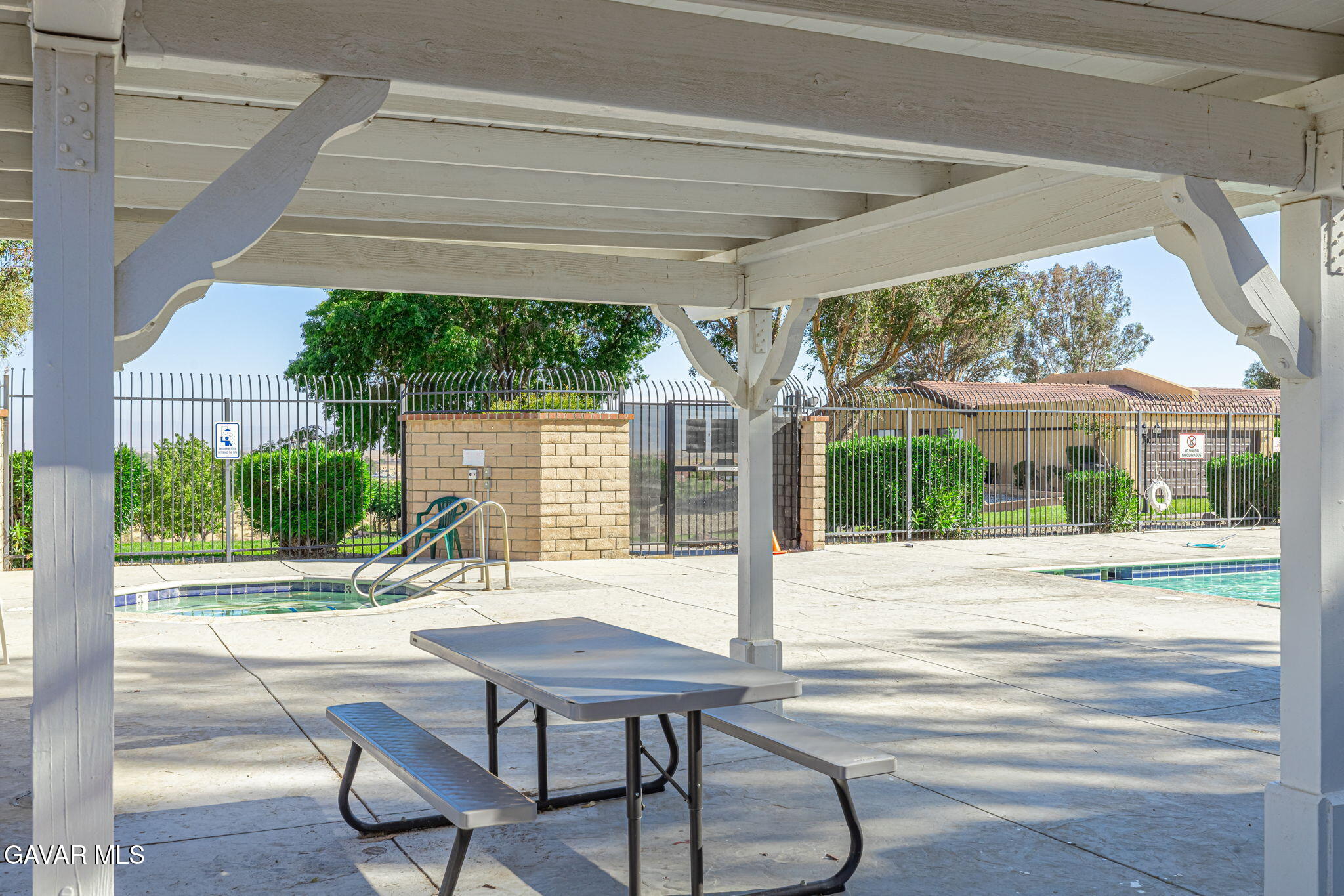 2400 Sunset Ridge Drive Rosamond, CA 93560 - Photo 25 of 34 a view of a patio with a table chairs and a small yard
