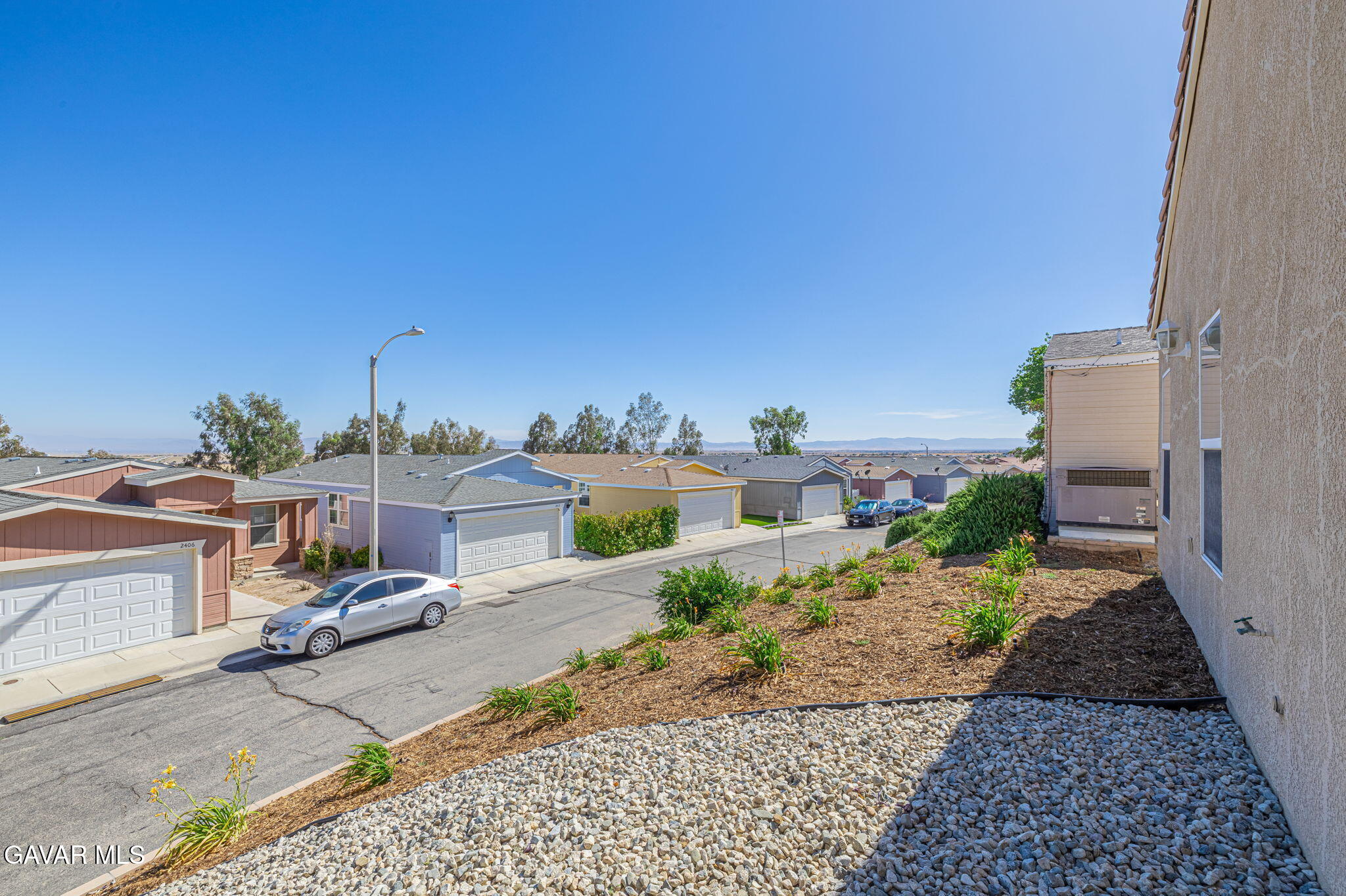 2400 Sunset Ridge Drive Rosamond, CA 93560 - Photo 29 of 34 a view of a patio with table and chairs a barbeque
