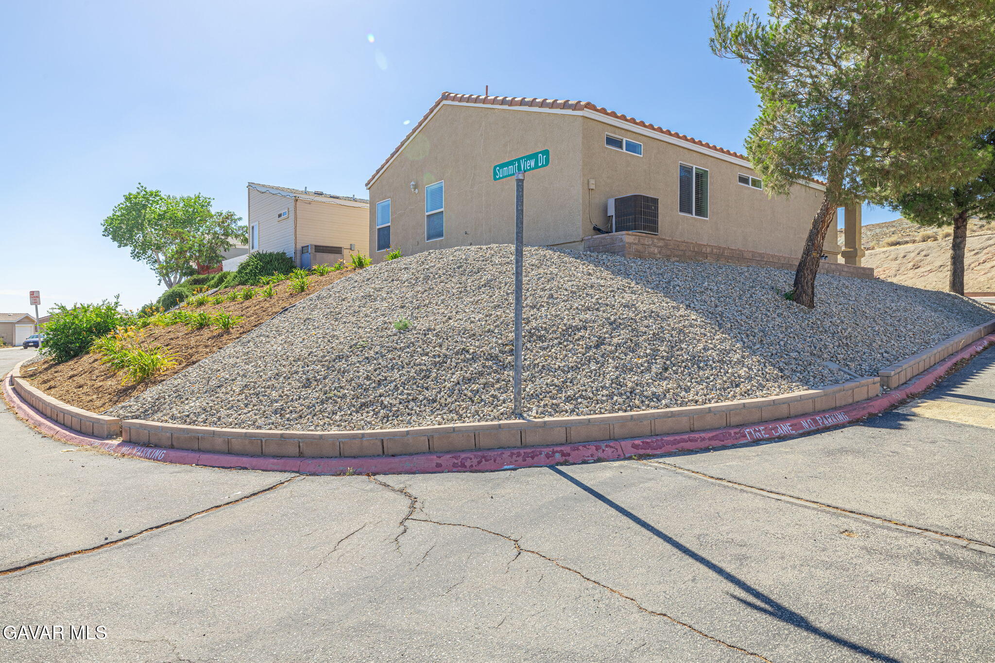 2400 Sunset Ridge Drive Rosamond, CA 93560 - Photo 33 of 34 a view of a house with a small yard and large tree