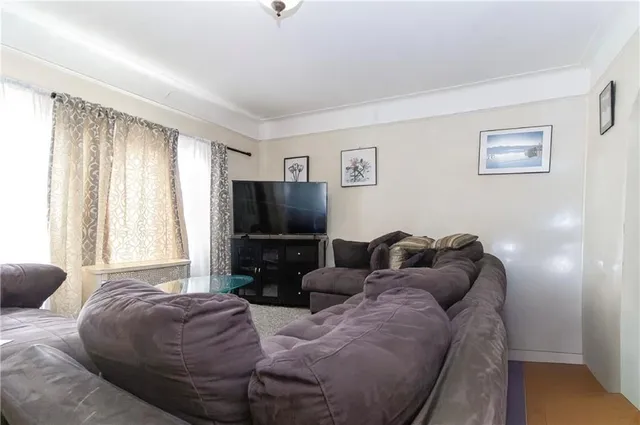 a living room with a couch and a flat screen tv
