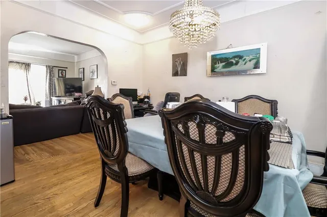 a view of a dining room with furniture and chandelier