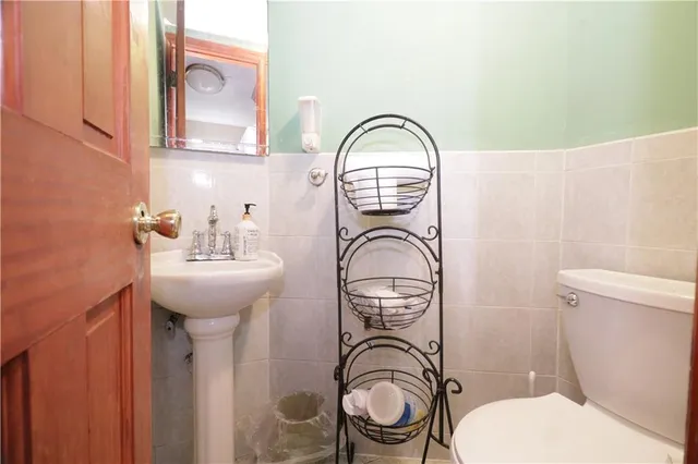 a bathroom with a toilet sink and mirror