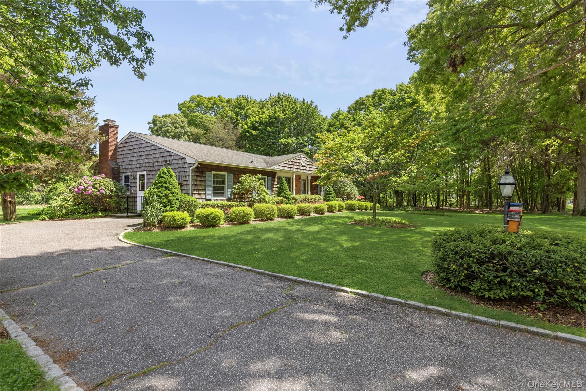 250 Paradise Point Road Southold, NY 11971 - Photo 19 of 24 a front view of a house with a yard and green space